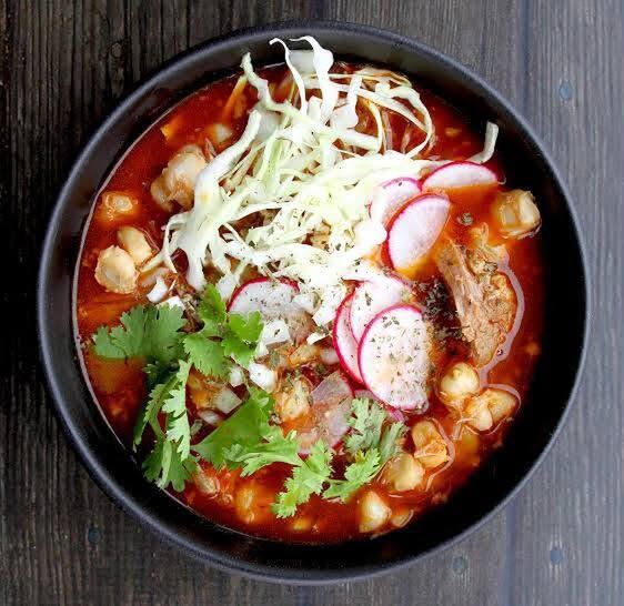 Red pork pozole topped with cabbage, radish and cilantro