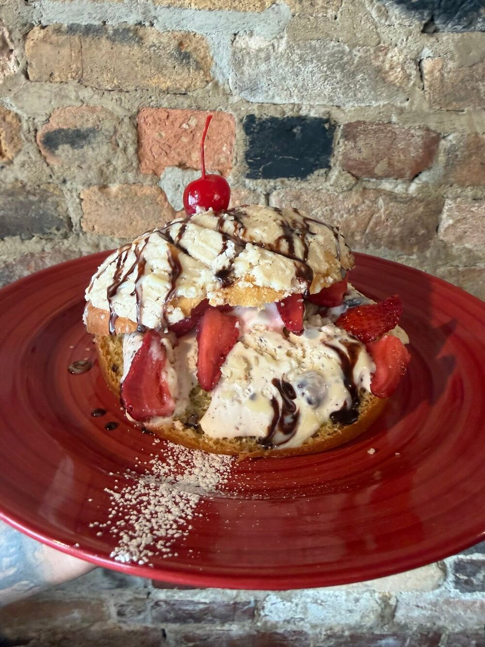A sweet brunch plate with strawberries, whipped cream and chocolate drizzle